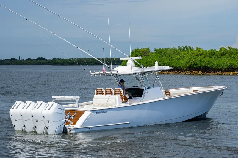 Slide: The Image of 2026 Valhalla V-41 boat cruising on water with multiple outboard engines. - 11