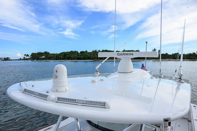 Slide: The Image of Valhalla V-41 2026 boat with Garmin radar on calm waters under blue sky. - 53