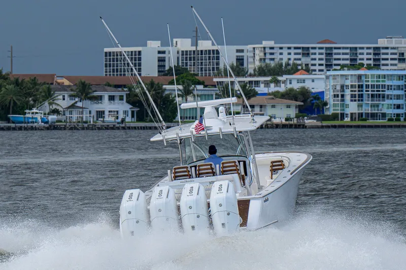 Slide: The Image of A 2026 Valhalla V-41 boat cruising on water with cityscape in the background. - 13