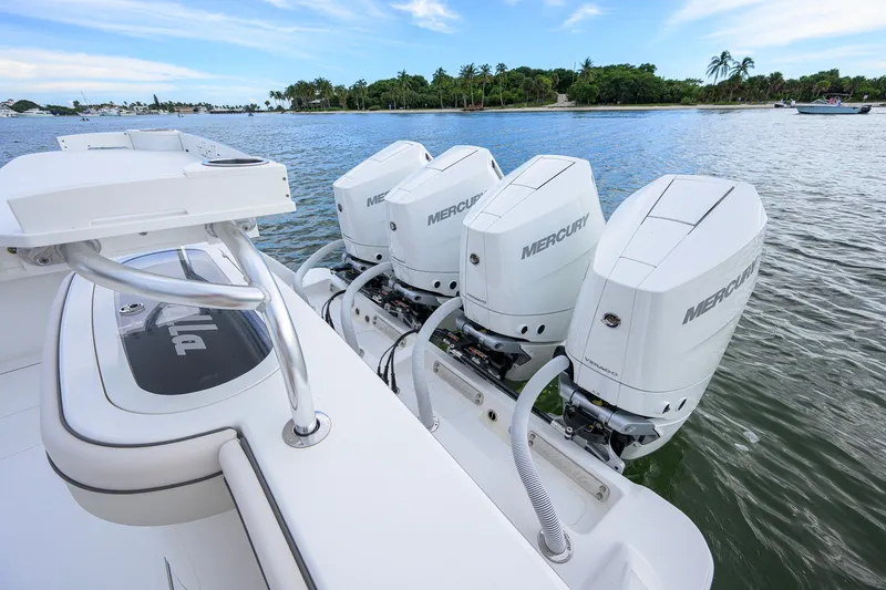 Slide: The Image of 2026 Valhalla V-41 boat with four Mercury outboard engines on a calm waterway. - 63