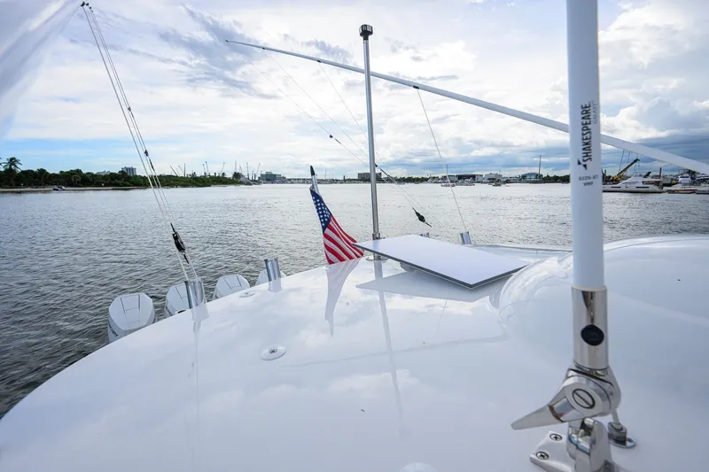 Slide: The Image of Valhalla V-41 yacht, 2026 model, cruising on a serene waterway with American flag. - 55