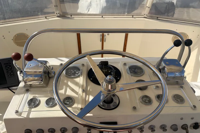 Slide: The Image of Helm of a 1972 Hatteras 38 Convertible boat with steering wheel and controls. - 8
