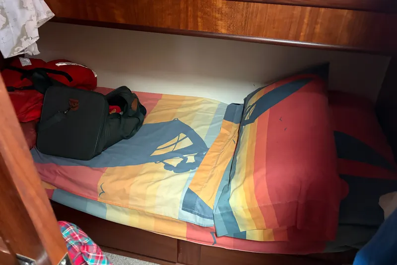 Slide: The Image of Cozy cabin bed with colorful bedding in a 1972 Hatteras 38 Convertible boat. - 29