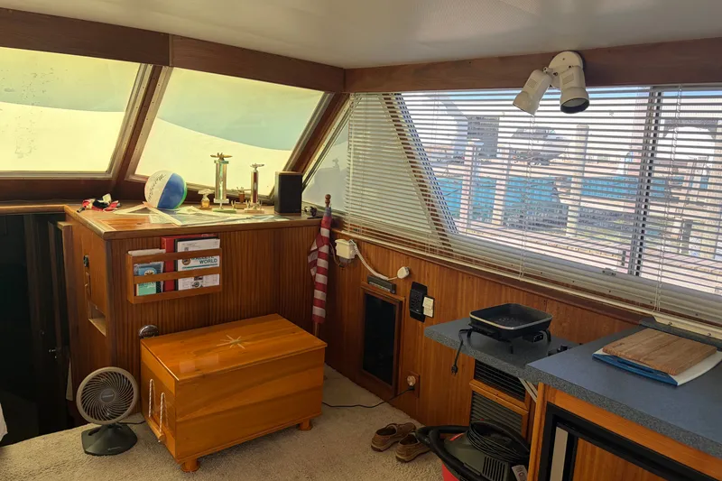 Slide: The Image of Interior of a 1972 Hatteras 38 Convertible yacht with wood paneling and nautical decor. - 22