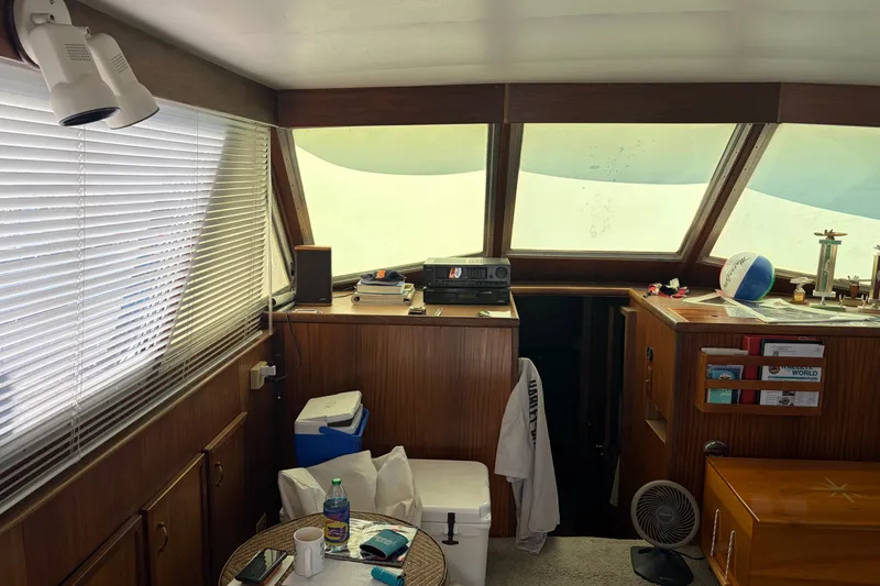 Slide: The Image of Interior of a 1972 Hatteras 38 Convertible boat with wood paneling and nautical decor. - 24