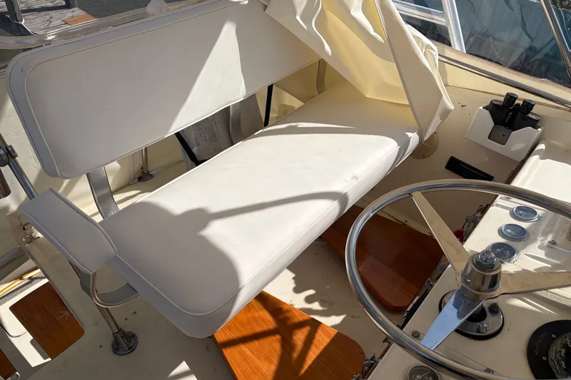 Slide: The Image of 1972 Hatteras 38 Convertible boat helm with white seating and steering wheel. - 18