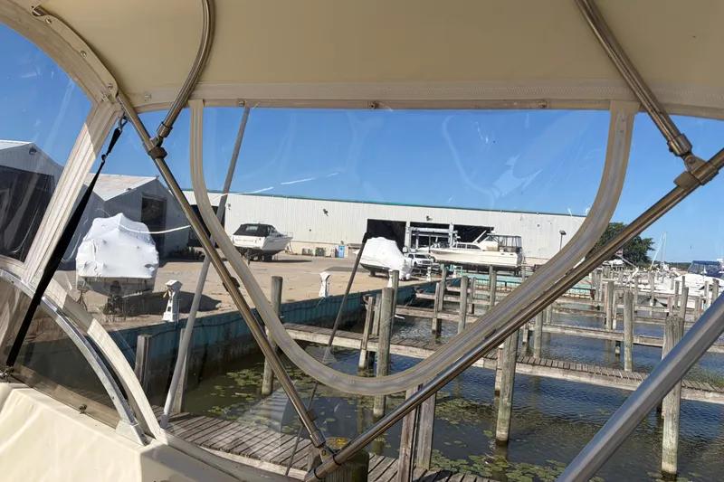 Slide: The Image of 1972 Hatteras 38 Convertible at marina with boats and docks in background. - 12