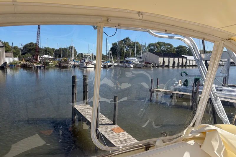 Slide: The Image of View from a 1972 Hatteras 38 Convertible boat overlooking a marina with docks and sailboats. - 15