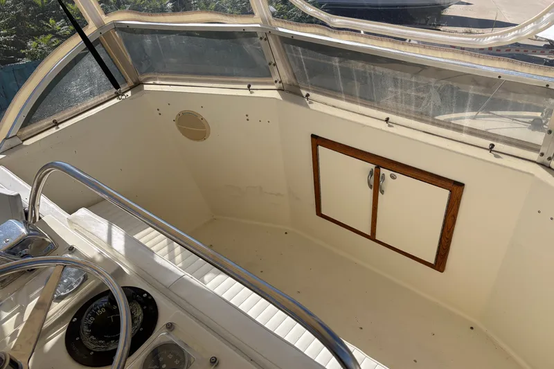 Slide: The Image of 1972 Hatteras 38 Convertible boat interior with steering wheel and storage cabinet. - 19