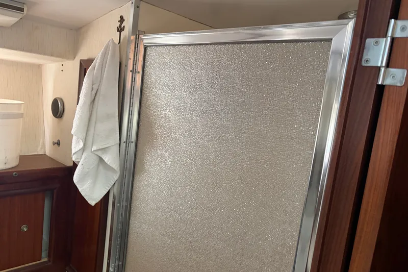 Slide: The Image of Interior of 1972 Hatteras 38 Convertible yacht showing bathroom with towel and textured shower door. - 27