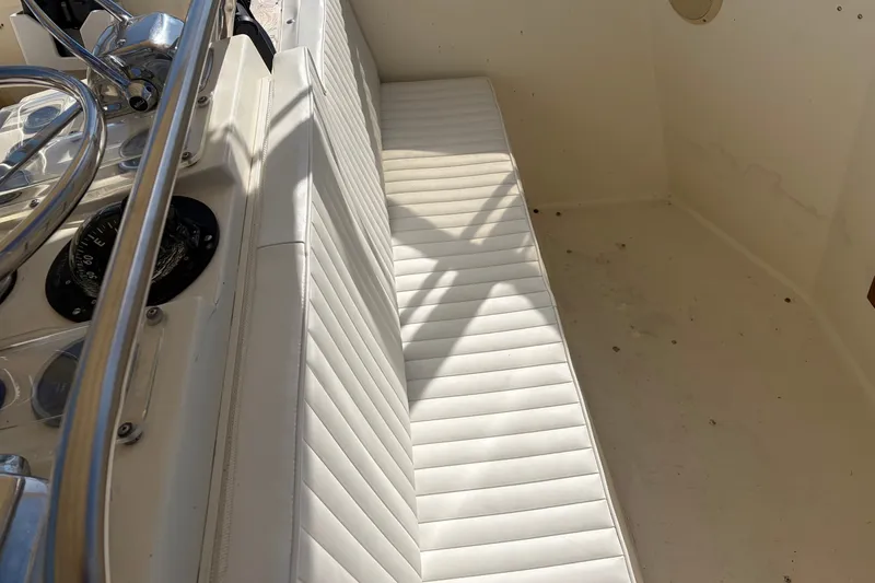 Slide: The Image of Interior view of a 1972 Hatteras 38 Convertible boat with white seating and steering controls. - 10
