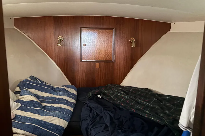 Slide: The Image of Interior cabin of a 1972 Hatteras 38 Convertible boat with cozy bedding. - 31