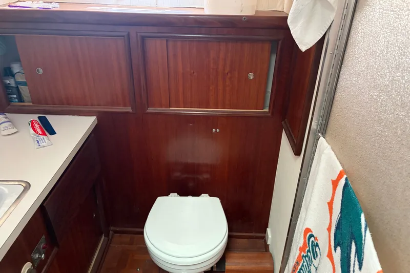 Slide: The Image of Bathroom interior of 1972 Hatteras 38 Convertible yacht with wooden cabinetry. - 26