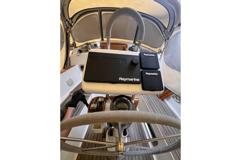 Slide: The Image of Steering wheel and Raymarine equipment on a 1995 Cabo Rico 34 sailboat. - 34