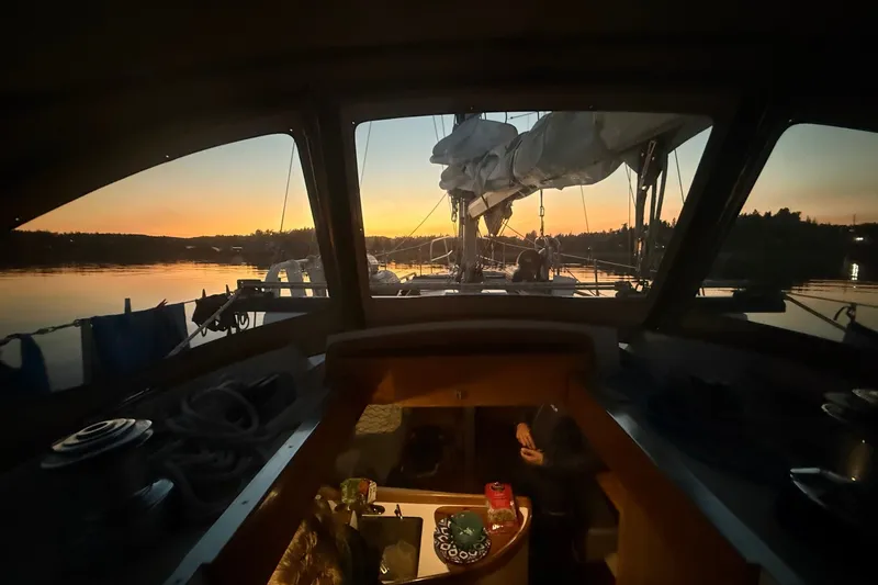 Slide: The Image of Cabo Rico 34 sailboat interior at sunset, 1995 model, serene water view. - 36
