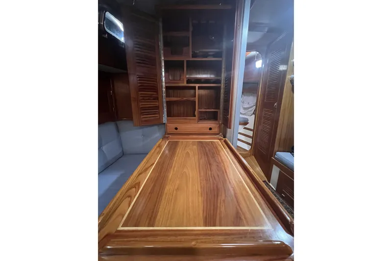 Slide: The Image of Interior of 1995 Cabo Rico 34 sailboat with wooden cabinetry and table. - 57