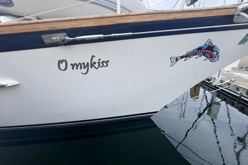 Slide: The Image of Cabo Rico 34 sailboat, 1995 model, with "O mykiss" name and fish artwork on hull. - 7