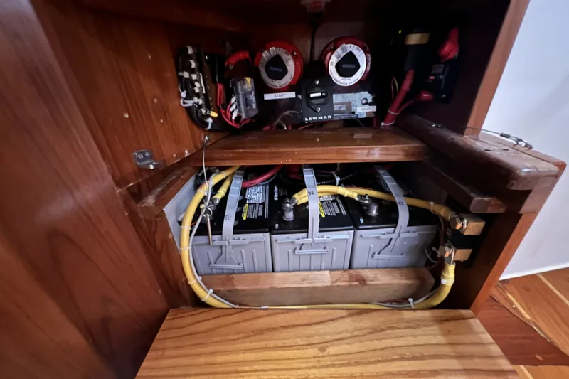 Slide: The Image of Electrical system of a 1995 Cabo Rico 34 sailboat, featuring batteries and wiring. - 78