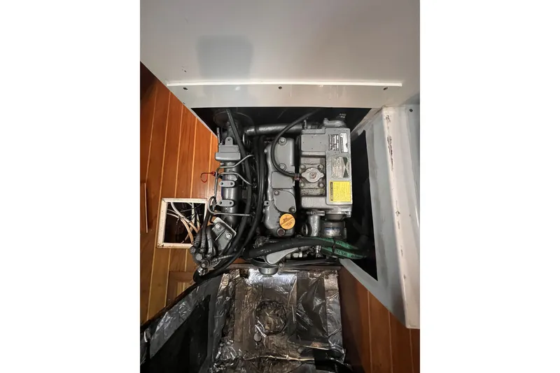 Slide: The Image of Engine compartment of a 1995 Cabo Rico 34 sailboat, showcasing mechanical components. - 71