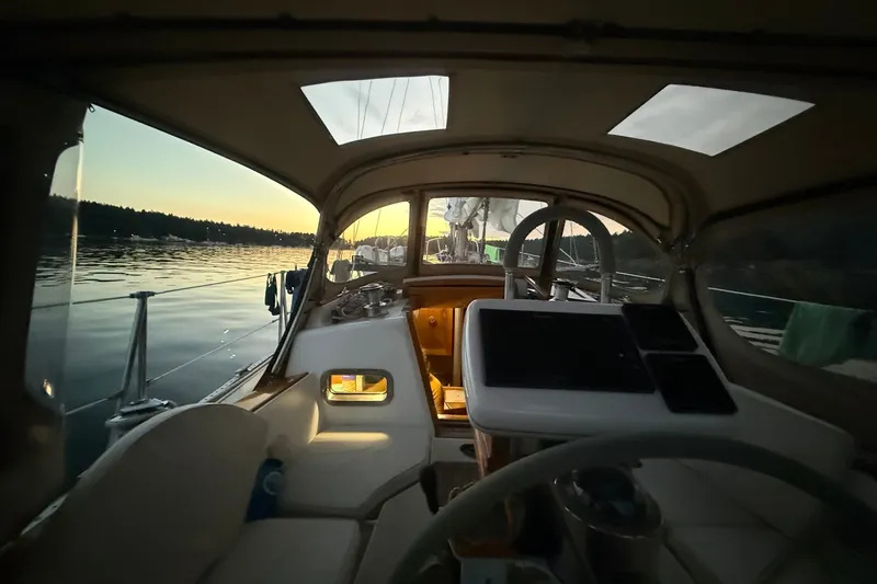 Slide: The Image of Interior view of a 1995 Cabo Rico 34 sailboat at sunset on calm waters. - 25