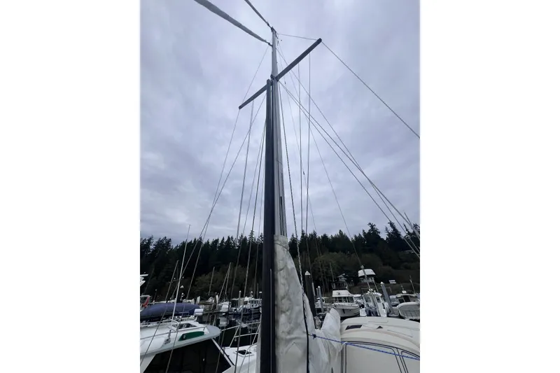Slide: The Image of Mast of 1995 Cabo Rico 34 sailboat docked at marina under cloudy sky. - 21
