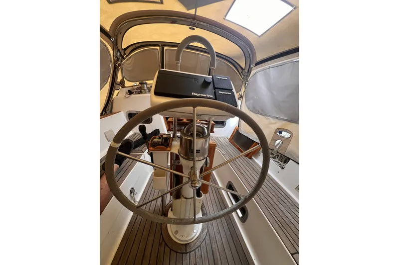 Slide: The Image of Steering wheel of a 1995 Cabo Rico 34 sailboat with navigation equipment. - 26