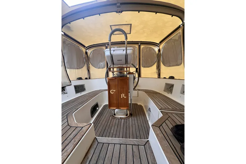 Slide: The Image of Interior view of a 1995 Cabo Rico 34 sailboat cockpit with wooden accents and seating. - 27