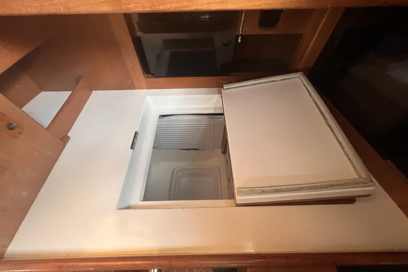 Slide: The Image of Interior view of a 1995 Cabo Rico 34 yacht's built-in refrigerator. - 40