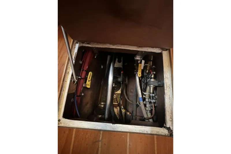 Slide: The Image of Engine compartment of a 1995 Cabo Rico 34 sailboat, showing mechanical components and hoses. - 75