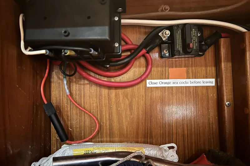 Slide: The Image of Electrical wiring and components inside a 1995 Cabo Rico 34, with safety instructions. - 80
