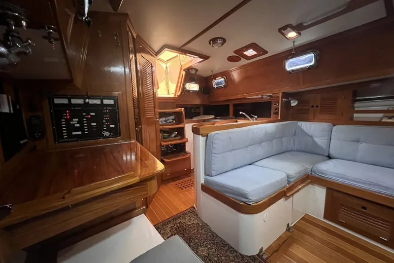Slide: The Image of Interior of a 1995 Cabo Rico 34 sailboat with wood finish and cushioned seating. - 45