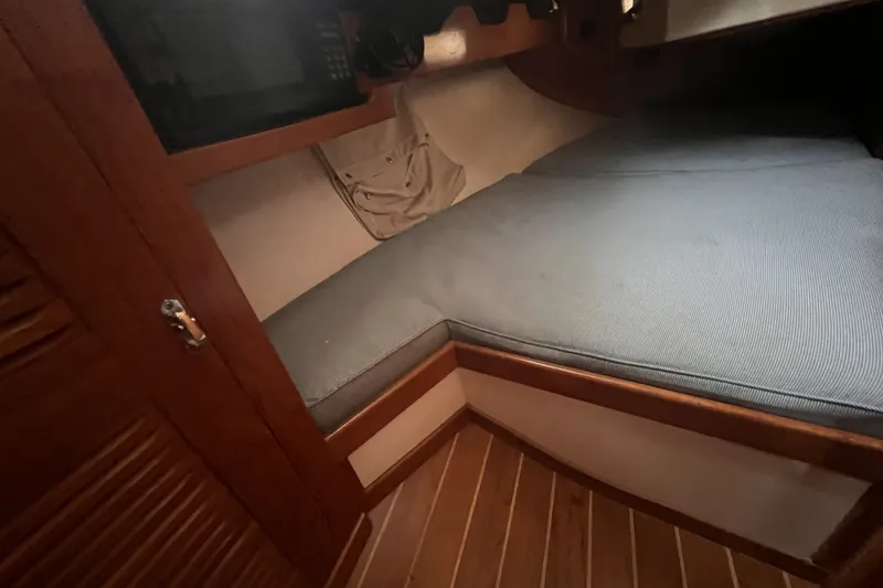 Slide: The Image of Interior cabin of 1995 Cabo Rico 34 sailboat with wooden finish and cushioned berth. - 52