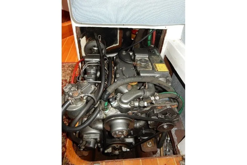 Slide: The Image of Engine of a 1995 Cabo Rico 34 sailboat, showcasing mechanical components and hoses. - 72