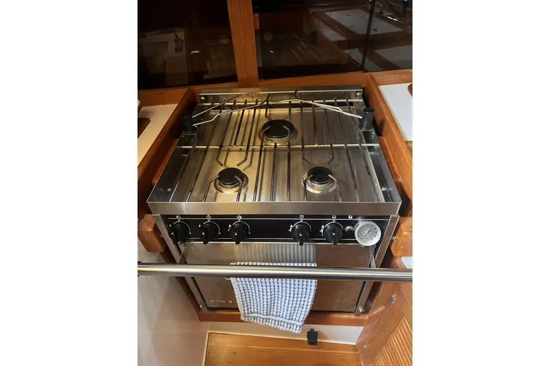 Slide: The Image of Stainless steel stove in 1995 Cabo Rico 34 yacht galley, featuring three burners and control knobs. - 41