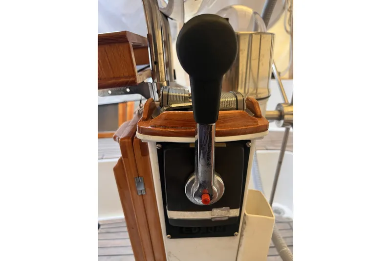 Slide: The Image of Throttle control on a 1995 Cabo Rico 34 sailboat, featuring wooden and metal elements. - 31