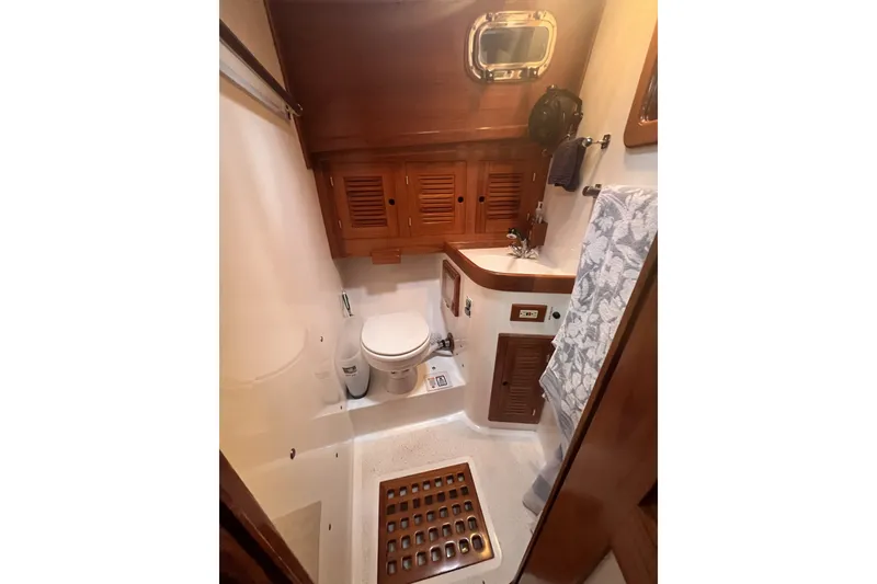 Slide: The Image of Bathroom interior of 1995 Cabo Rico 34 yacht with wooden cabinetry and nautical decor. - 62