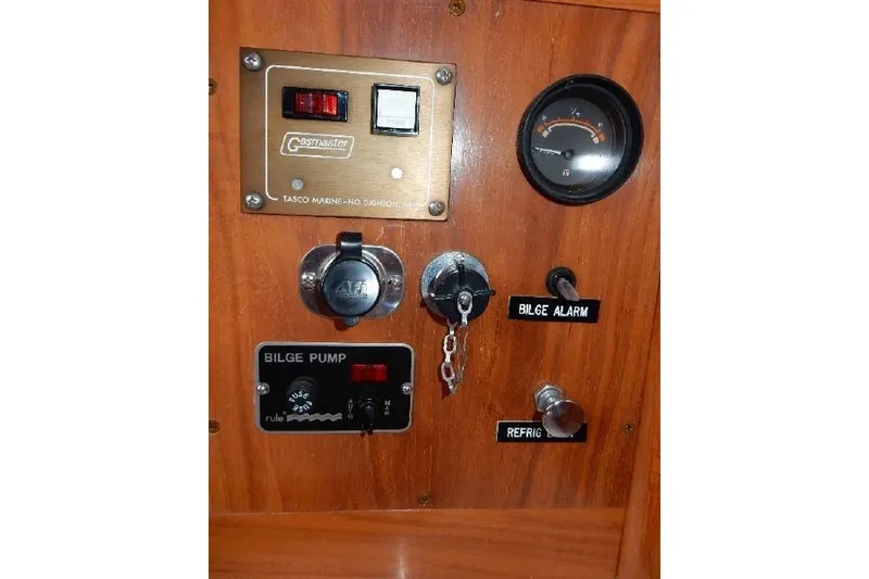 Slide: The Image of Control panel of a 1995 Cabo Rico 34 sailboat with various switches and gauges. - 50