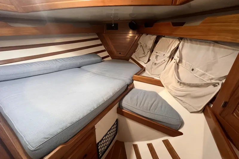 Slide: The Image of Cozy cabin interior of 1995 Cabo Rico 34 sailboat with blue cushions and wooden accents. - 66