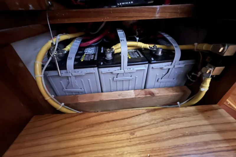 Slide: The Image of Battery compartment of a 1995 Cabo Rico 34 sailboat with secured wiring. - 77