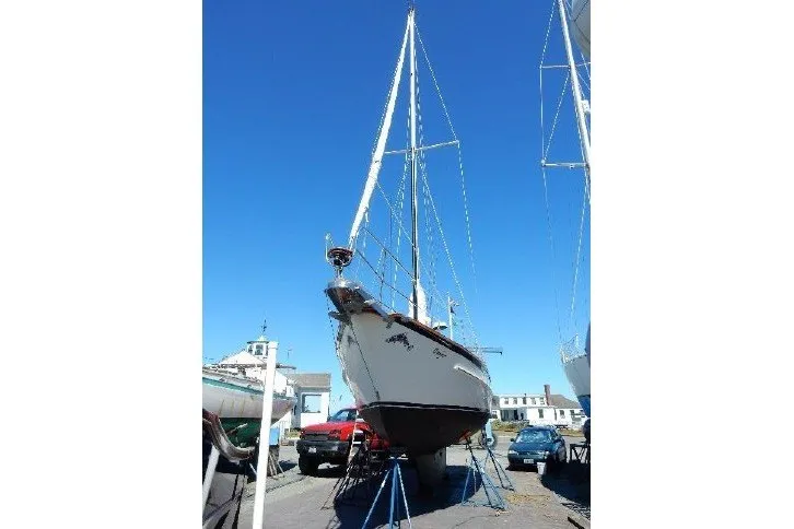 Slide: The Image of 1995 Cabo Rico 34 sailboat on stands, clear blue sky background. - 84