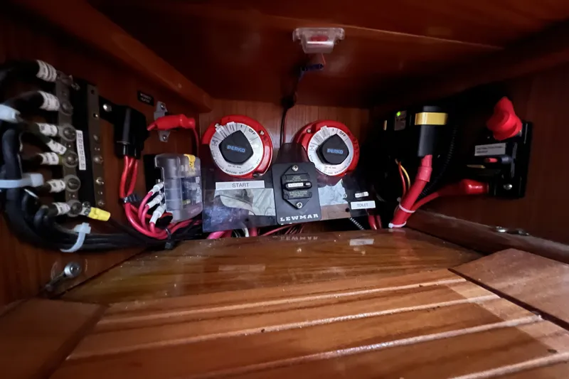 Slide: The Image of Electrical panel of a 1995 Cabo Rico 34 sailboat, featuring wiring and switches. - 76