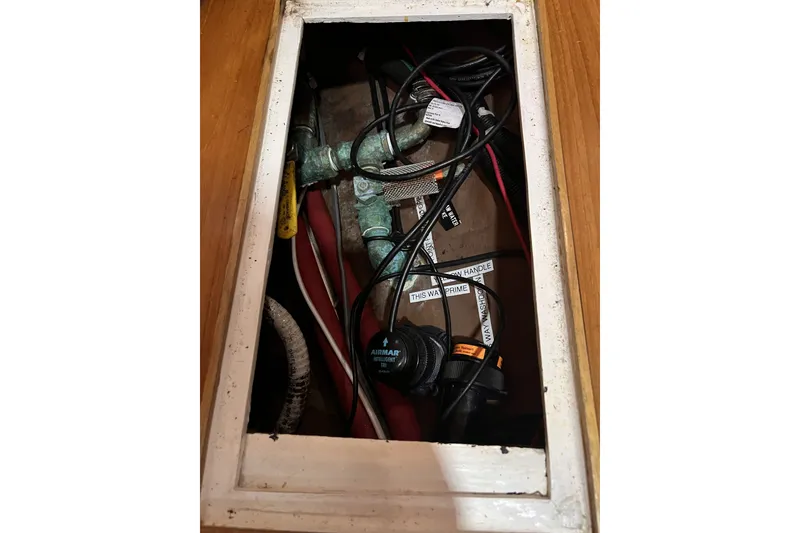 Slide: The Image of Bilge compartment of 1995 Cabo Rico 34 sailboat with wiring and plumbing. - 81