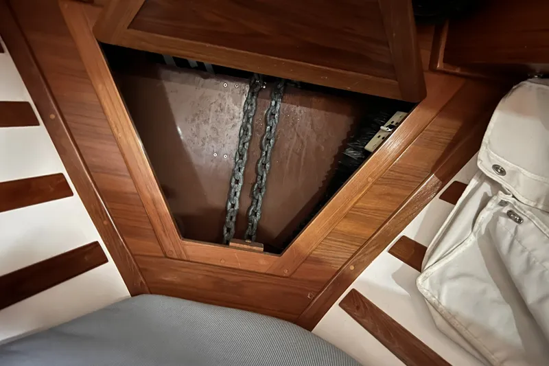 Slide: The Image of Interior view of a 1995 Cabo Rico 34 sailboat showing anchor chain storage. - 67