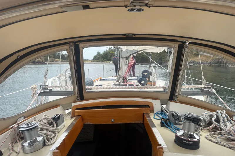 Slide: The Image of Cockpit view of a 1995 Cabo Rico 34 sailboat, showcasing ropes and winches. - 35