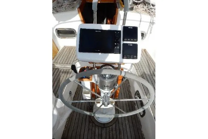 Slide: The Image of Cockpit of 1995 Cabo Rico 34 sailboat with steering wheel and navigation instruments. - 33