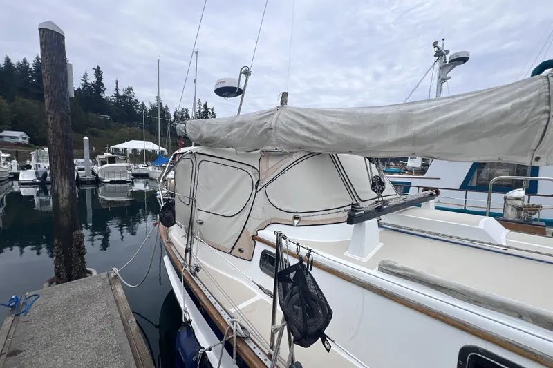 Slide: The Image of Sailboat Cabo Rico 34, 1995 model, docked at marina with overcast sky. - 15