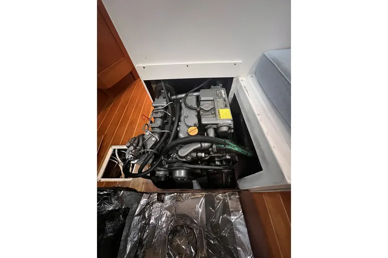Slide: The Image of Engine compartment of a 1995 Cabo Rico 34 sailboat, showcasing detailed mechanical components. - 70