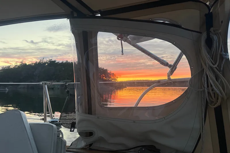 Slide: The Image of Cabo Rico 34 sailboat interior view with stunning sunset over calm waters, 1995 model. - 32