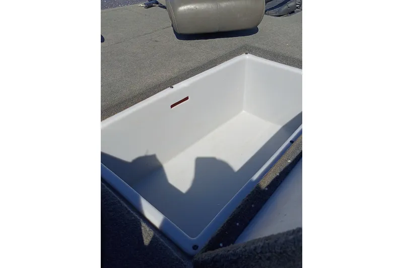 Slide: The Image of 2017 Stratos 176 VLO boat storage compartment with gray carpeted deck. - 14