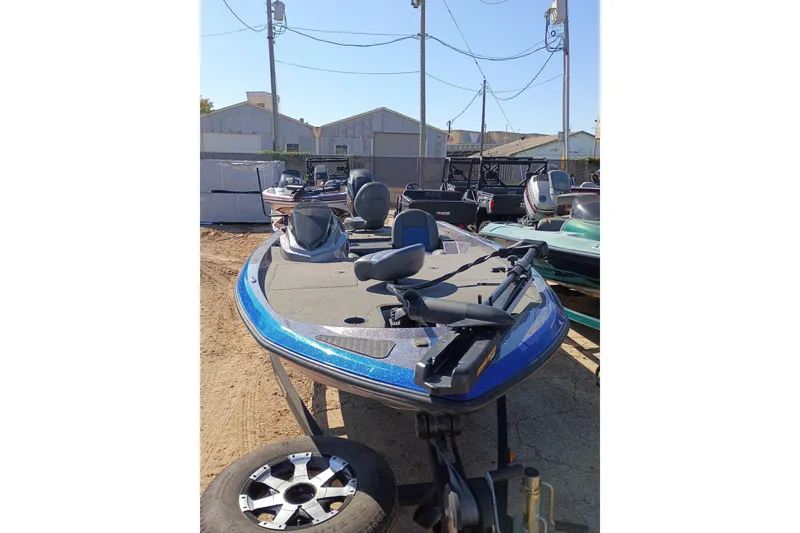 Slide: The Image of 2017 Stratos 176 VLO boat in a yard, featuring blue accents and fishing seats. - 1